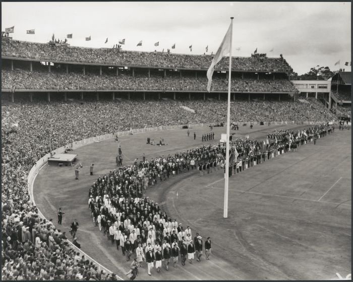 Black and white photo of athletes marching during the closing ceremony of the 1956 Melbourne Olympics.