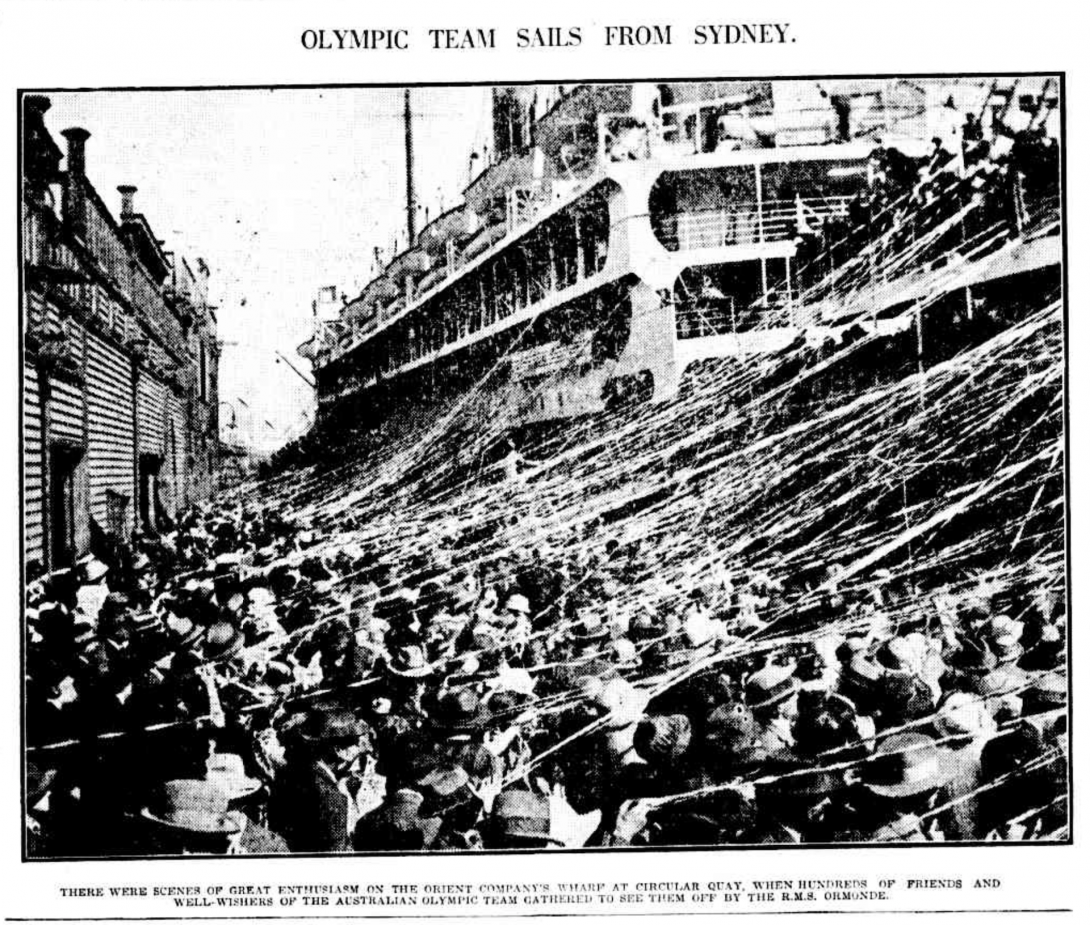 Black and white photo of streamers hanging between a boat about to depart and a large crowd seeing it off.