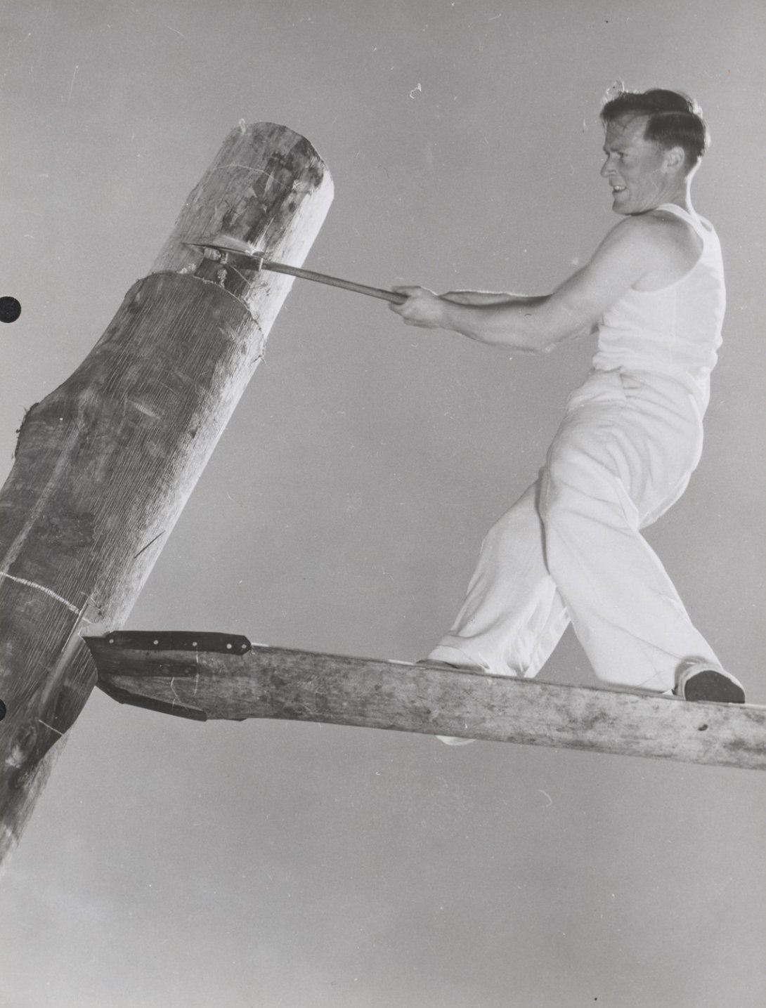 Ray Youd competing in the woodchopping event at the Royal Agricultural Show in Melbourne, Victoria, 1957