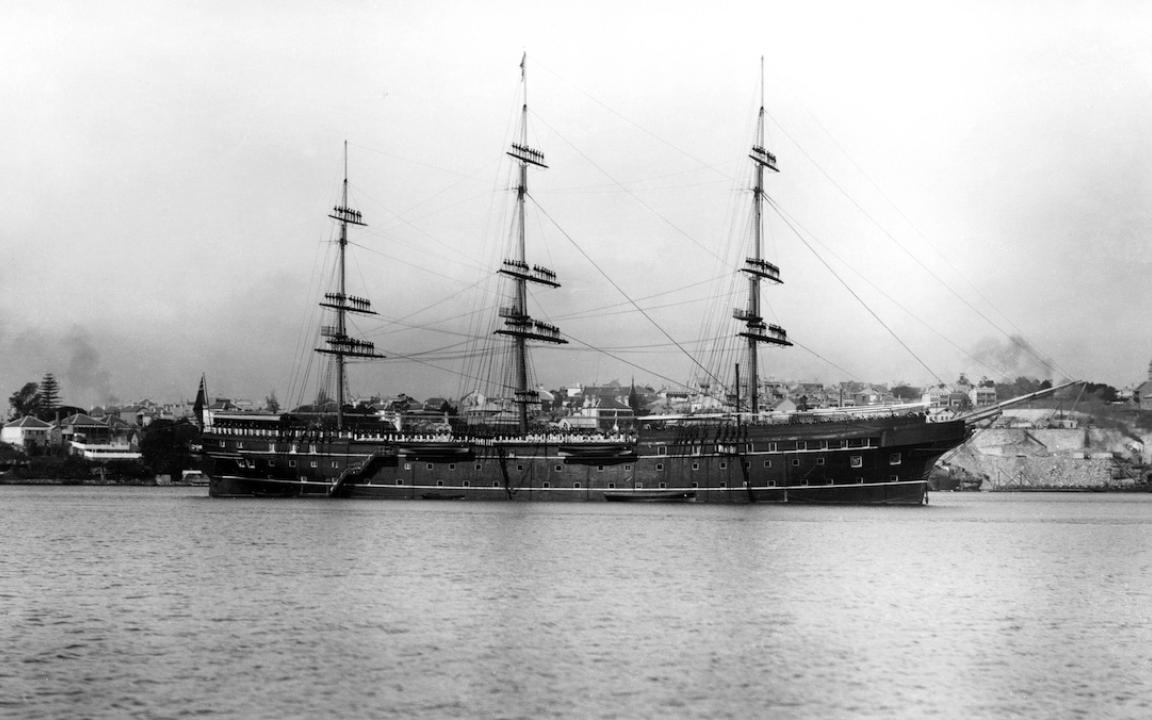 Black and white photo of a large ship in a harbour