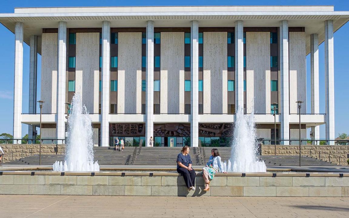 The front of the National Library building showing fountains and steps