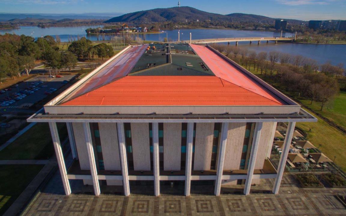 An aerial view of the National Library building featuring an angled orange roof