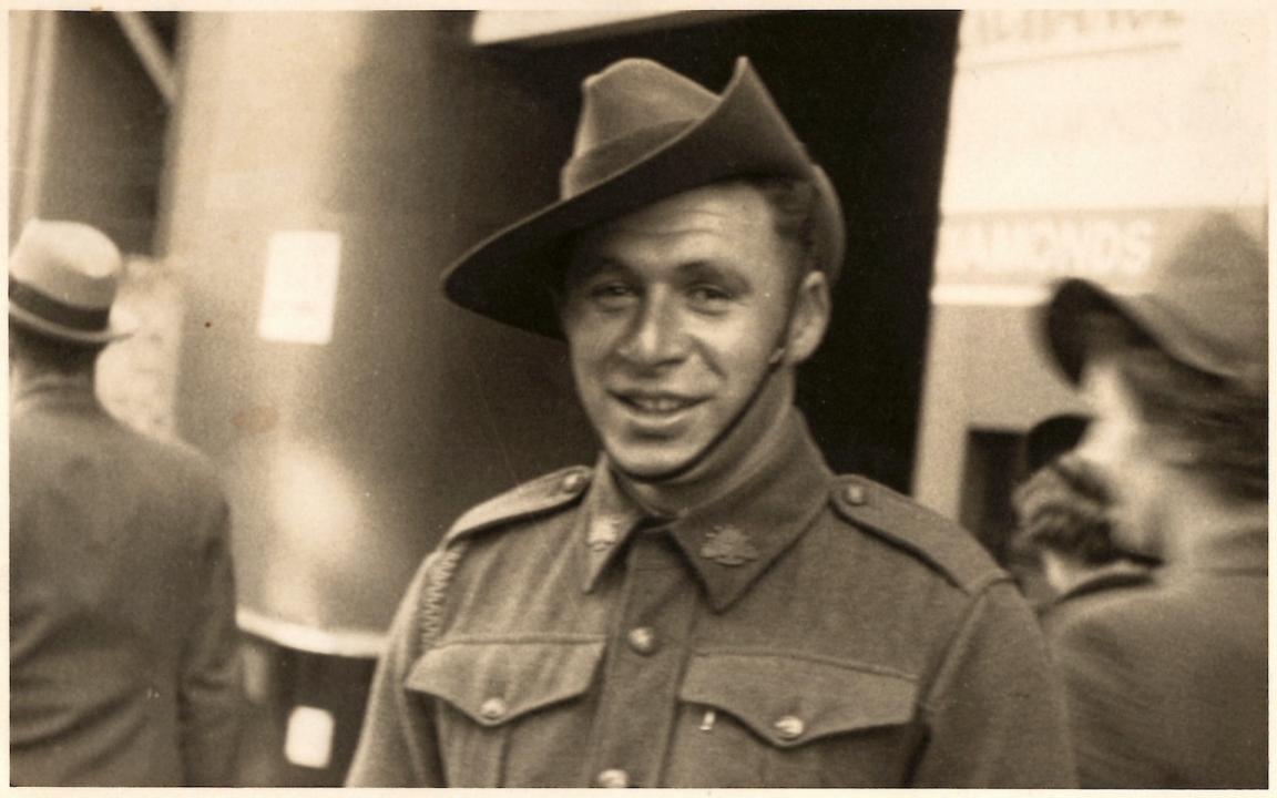 Man in military uniform with hat smiling