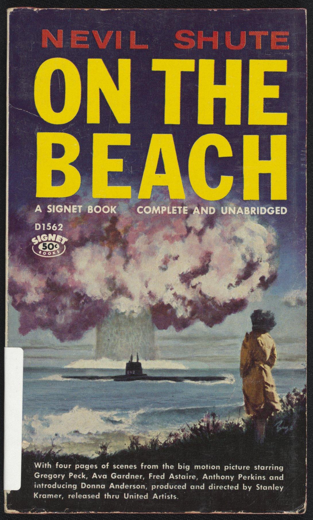 Book cover showing a woman standing on the shore, watching a mushroom cloud come up from the sea. The name of the book 'On the beach' is in large yellow text below the author's name 'Nevil Shute' in red text