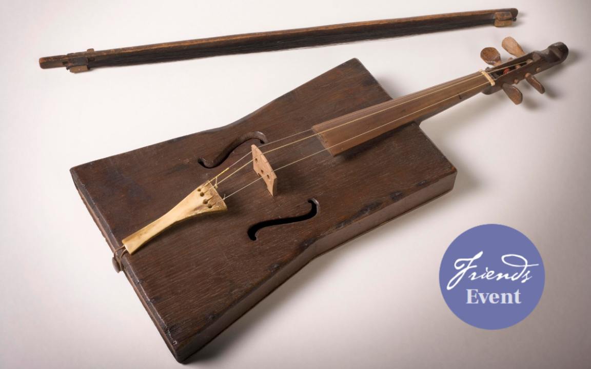 A violin and bow crafted from a stockman's tucker box and a purple sticker signalling that this is a Friends of the Library event.