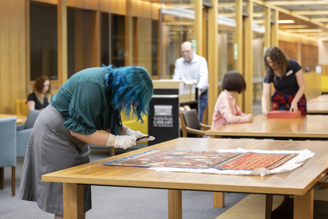 People looking at collection material and moving around the Special Collections Reading Room 